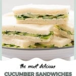 Cucumber sandwiches on a white cake stand in front of a white wall on a white marble bench top.
