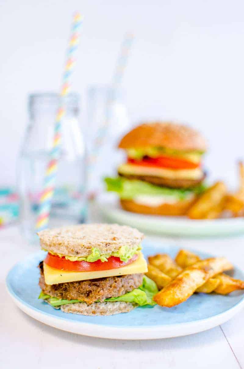 small kids burger on a blue plate, fries on the side