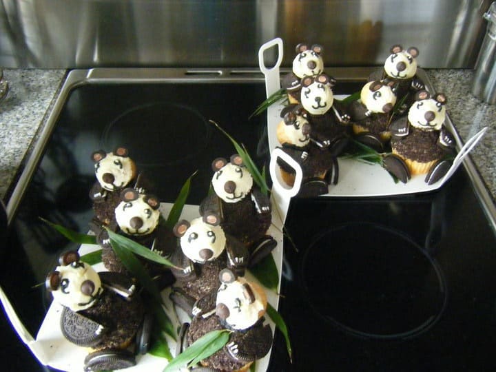 Photo of original panda cupcakes placed on plastic plates with handles. 