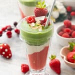 A red green and white smoothie in a tall sundae glass with text overlay: Christmas Smoothies