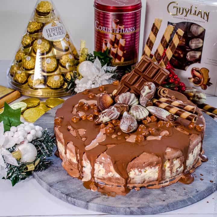 A delicious triple layer Christmas chocolate hazelnut ice-cream cake! Chocolate, vanilla and hazelnut flavoured ice-cream layers packed full of Christmas treats, Ferrero Rocher, Guylian Chocolates and More