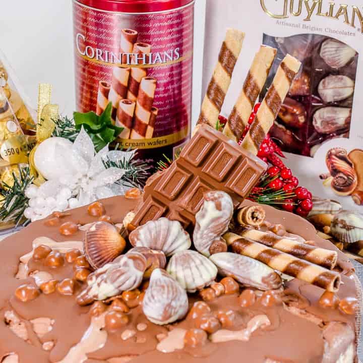 A delicious triple layer Christmas chocolate hazelnut ice-cream cake! Chocolate, vanilla and hazelnut flavoured ice-cream layers packed full of Christmas treats, Ferrero Rocher, Guylian Chocolates and More