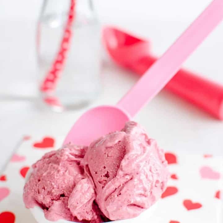 bowl of strawberry vegan ice cream on a red and white napkin