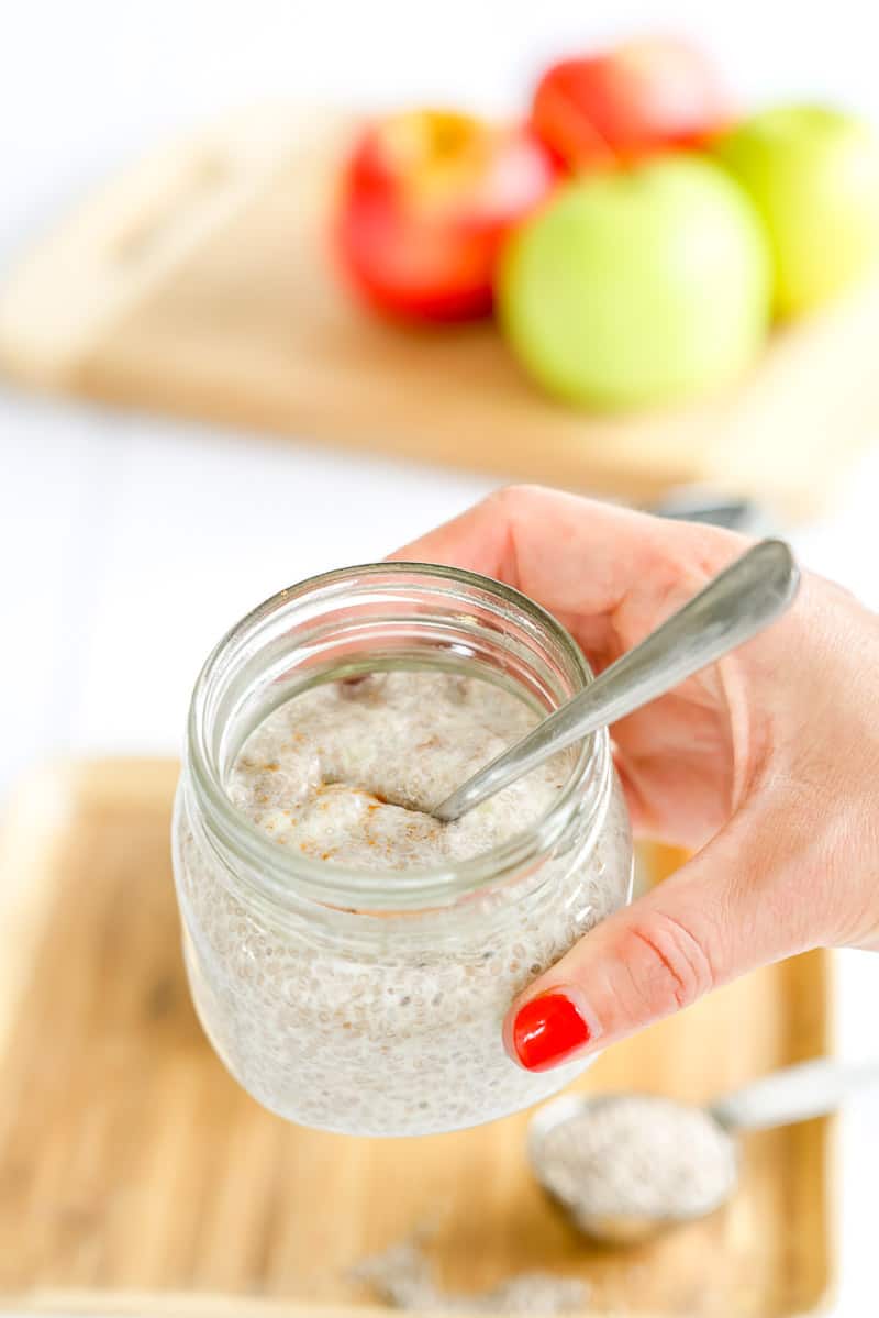 Hand holding a jar of chia pudding