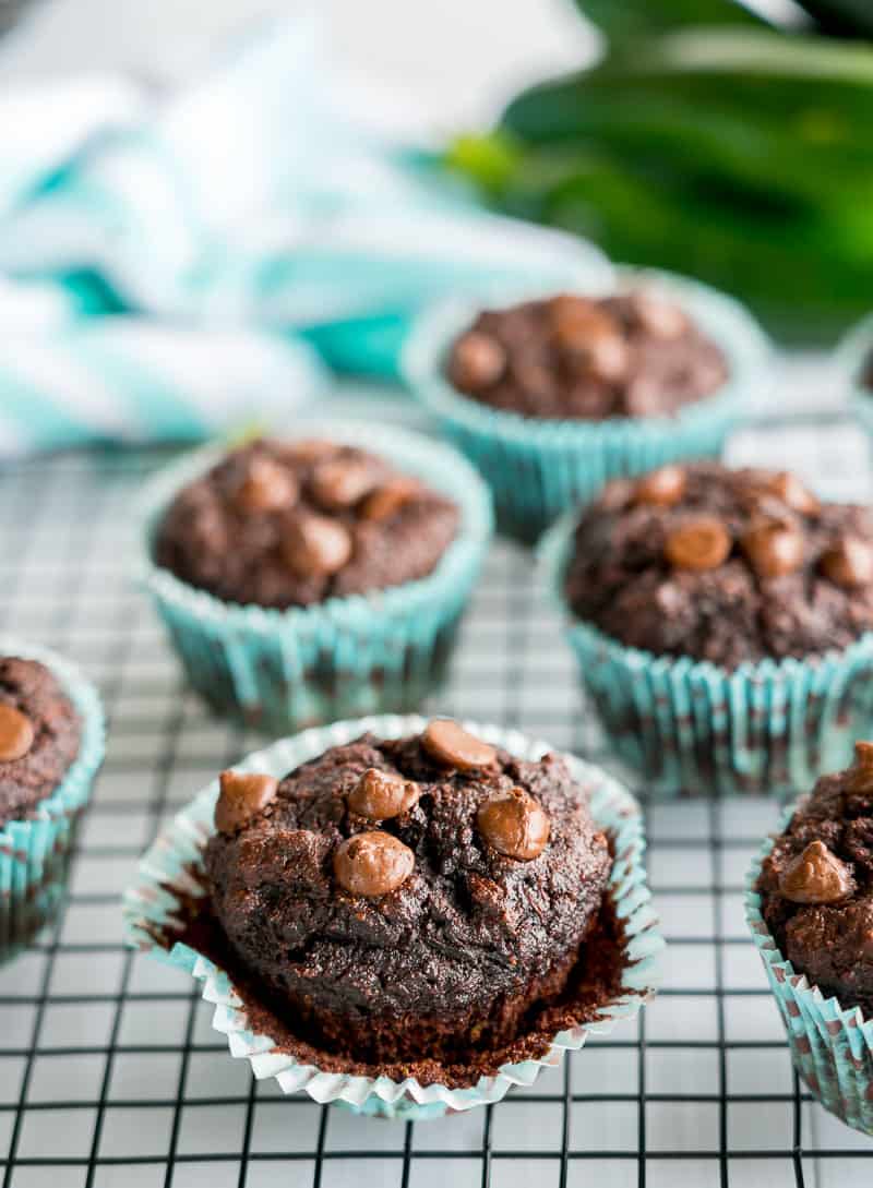 Zucchini Muffins Double Choc Grain free sitting on a cooling rack in blue spotted muffin liners