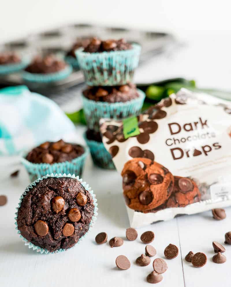 Double Chocolate Grain Free Zucchini on a white surface with a packet of dark chocolate drops