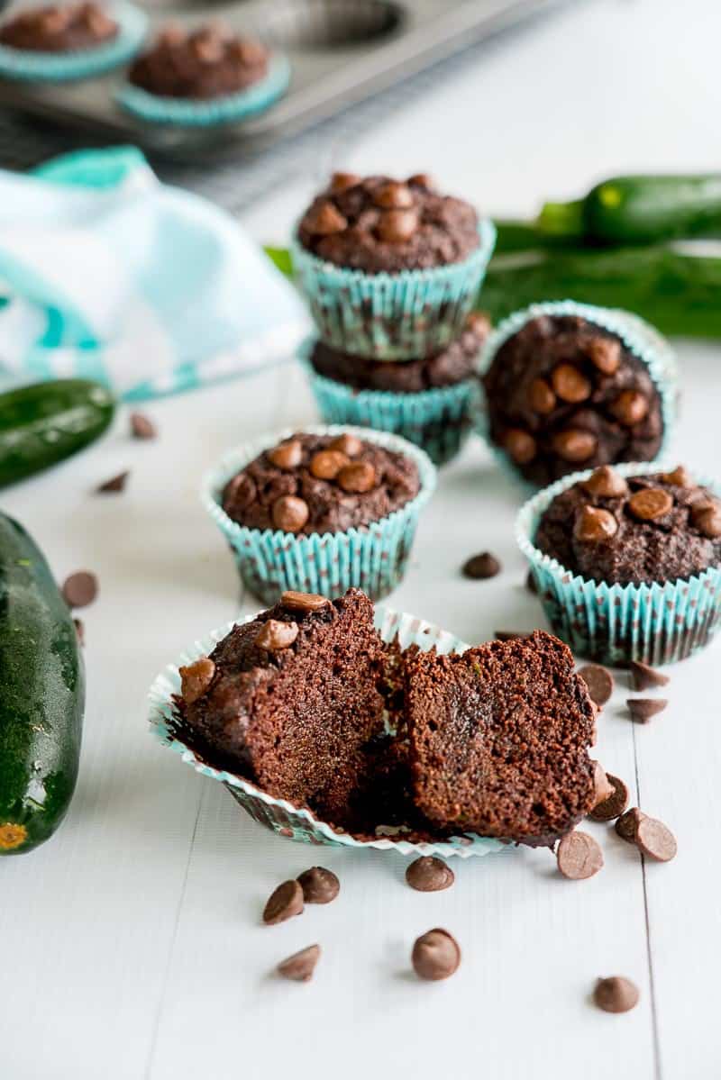 Double Chocolate Zucchini Muffins, 1 muffin cut in half showing moist fudgy consistency
