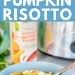 pumpkin risotto in a blue bowl, topped with feta and pinenute