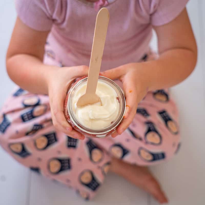 strawberry chia yoghurt parfait small child holding one wearing pink pyjamas