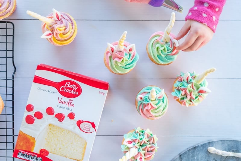 Unicorn Cupcakes, iced and uni iced cupcakes on a cooling rack