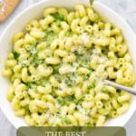 A large bowl of pasta with a pesto sauce and green peas, with text overlay for pinterest.