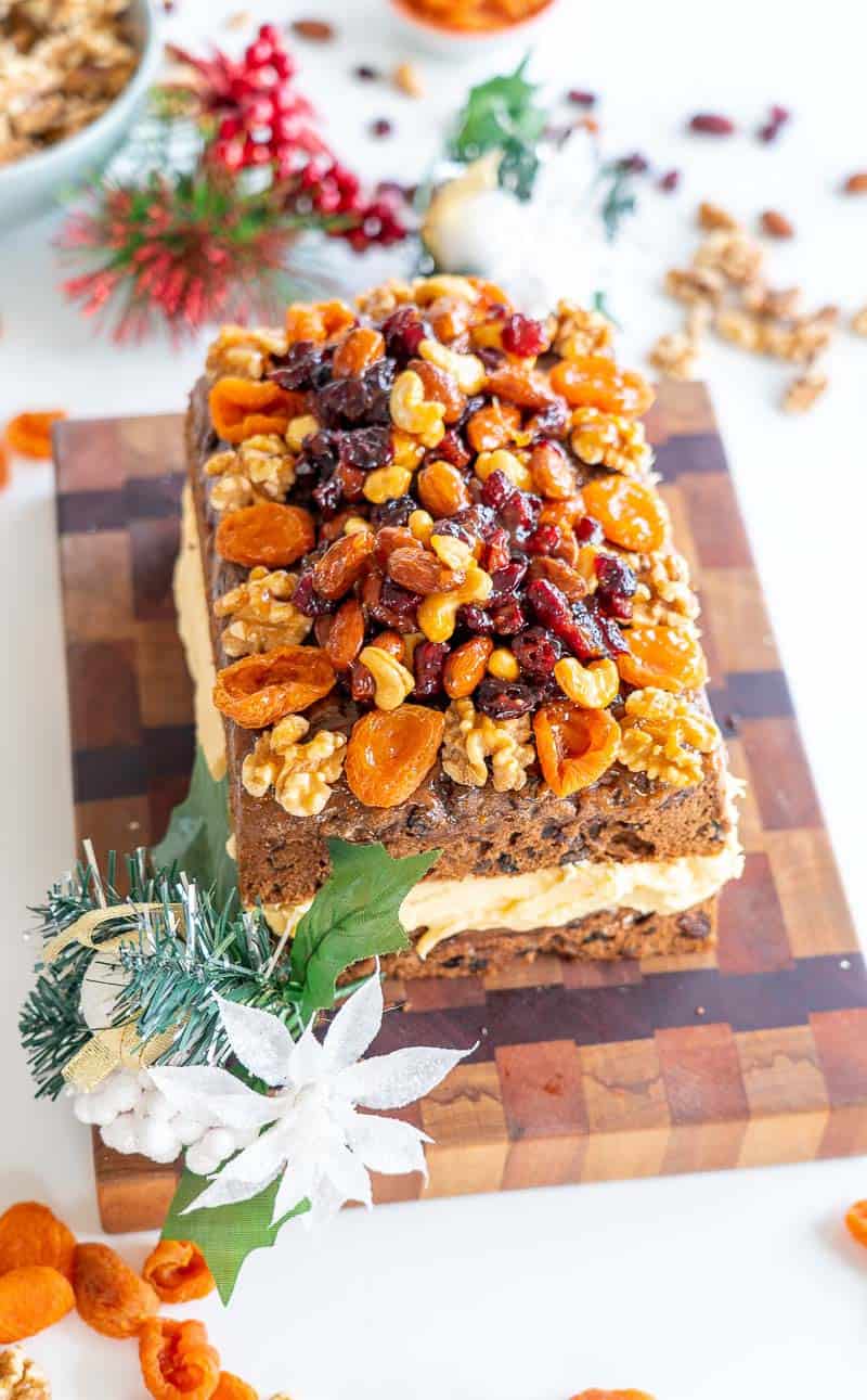 Christmas cake filled with buttercream and topped with a fruit and nut crusr