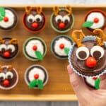 A reindeer cupcake being held up to the camera.