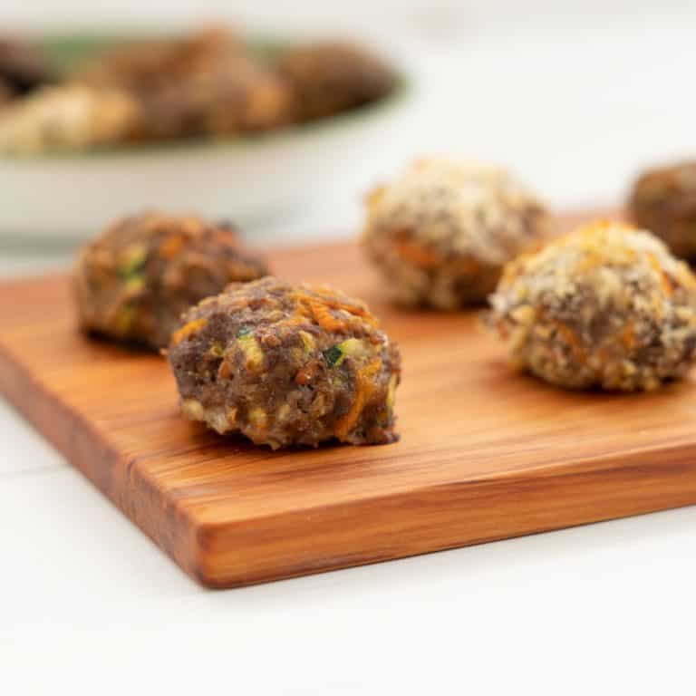 rissoles sitting on a wooden board