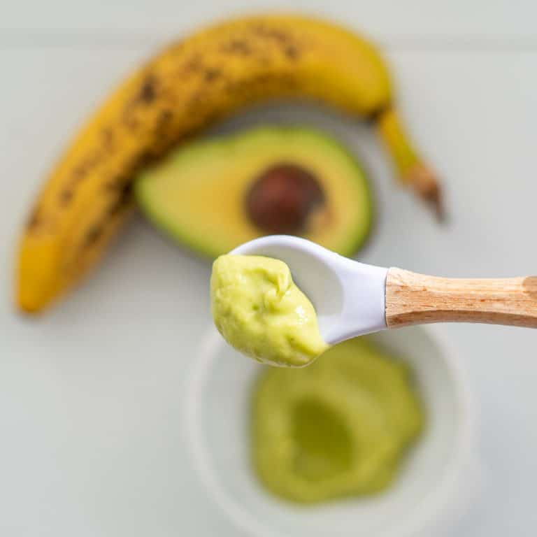 smooth avocado baby food on a bamboo handled bamboo spoon