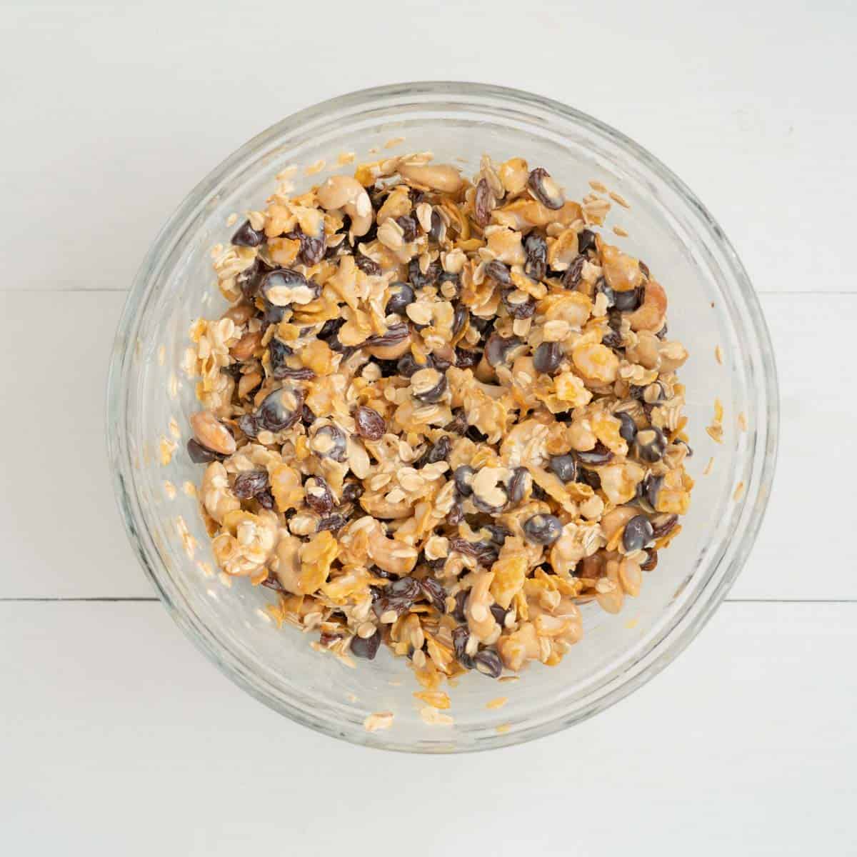 Cereal, nuts, dried fruits and chocolate drops mixed together in a bowl