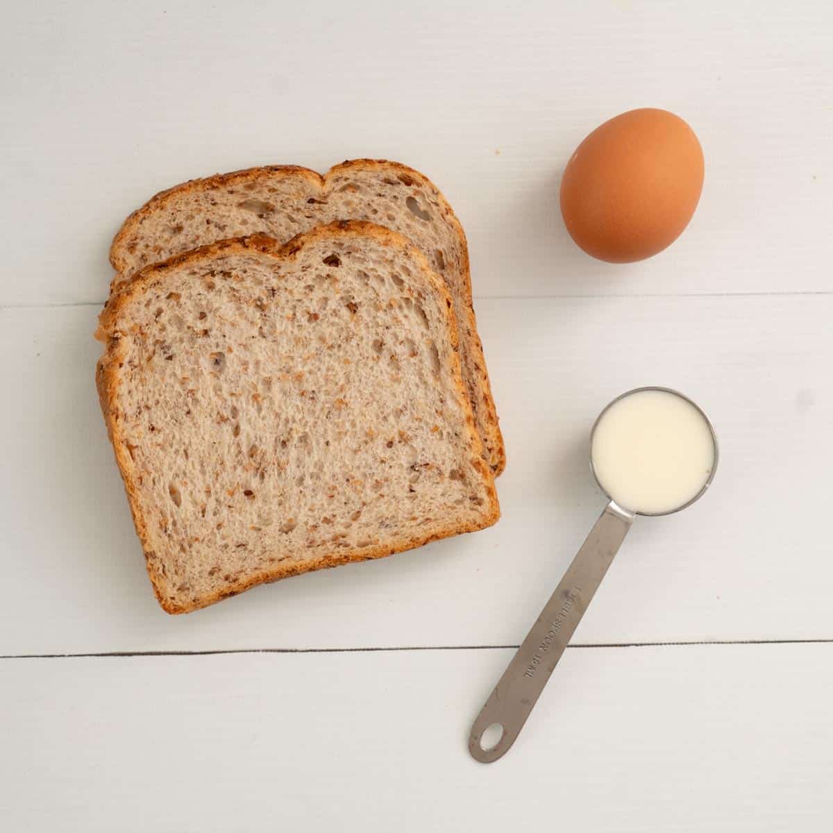 2 slices of grainy bread, 1 Tbsp of milk, 1 egg