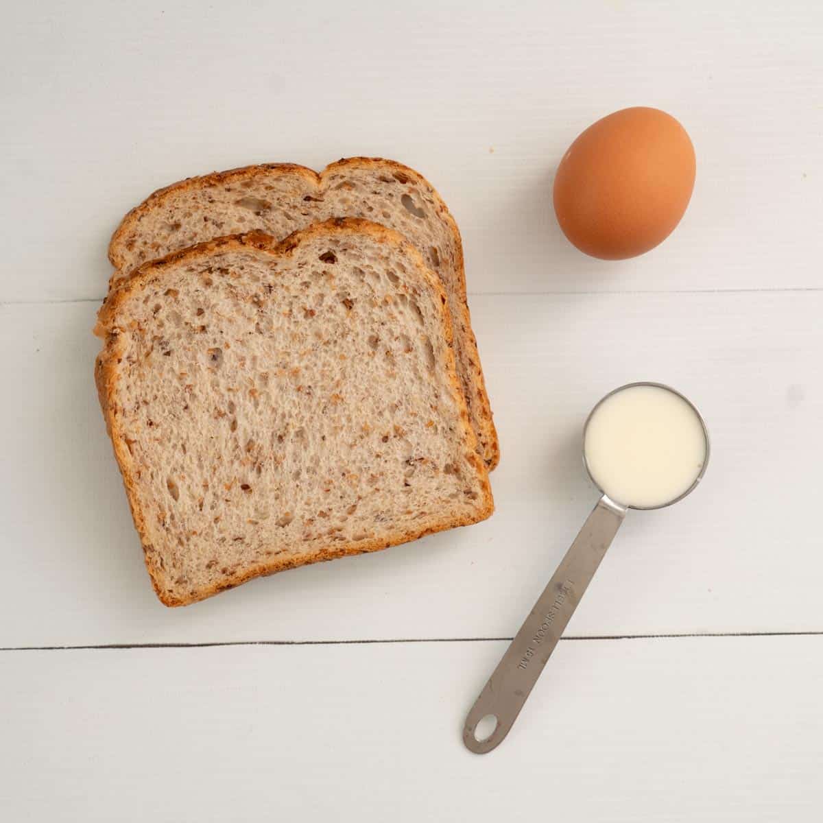 2 slices of grainy bread, 1 tablespoon of milk, 1 egg