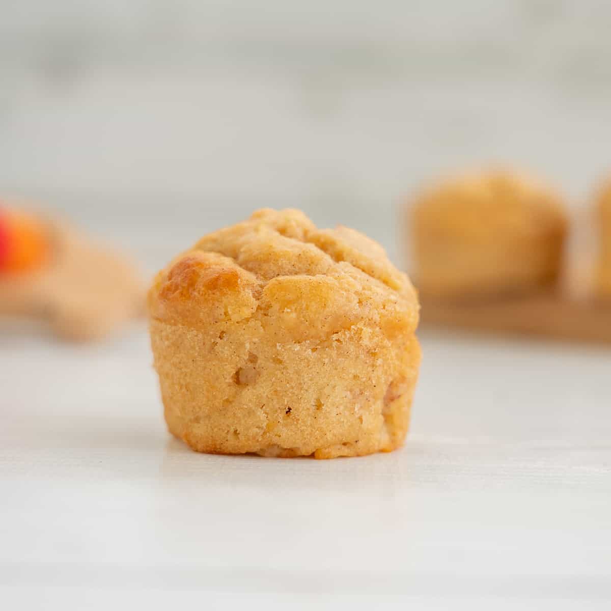 a mini applesauce muffin on a white counter top