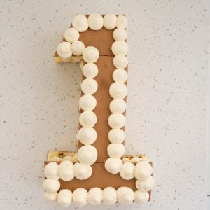 number 1 shaped birthday cake, decorated with whipped cream