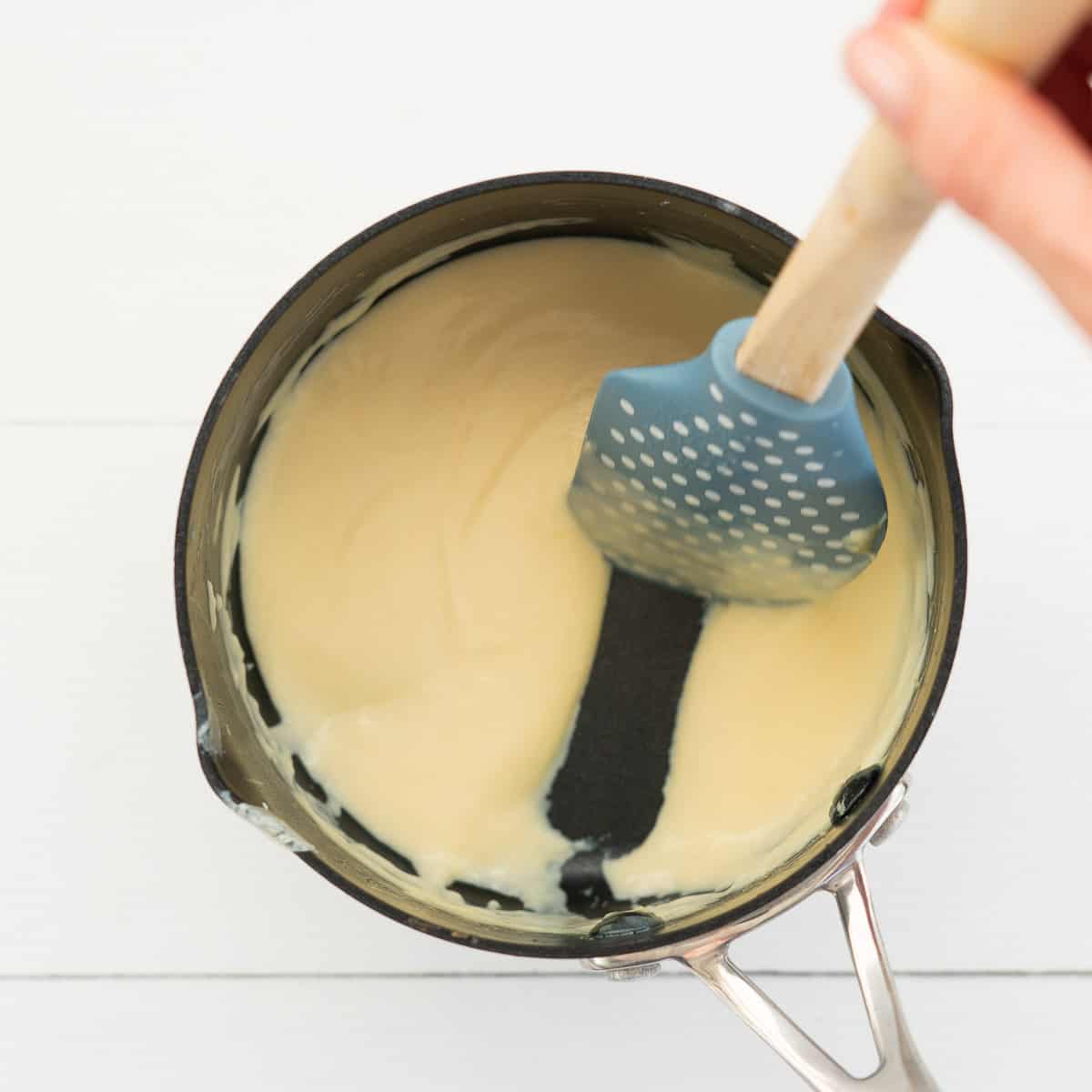 thickened custard in a pot, thick enough for a spatula to form a channel when drawn through the mix