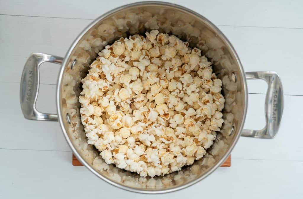 A large saucepan half full of popped popcorn