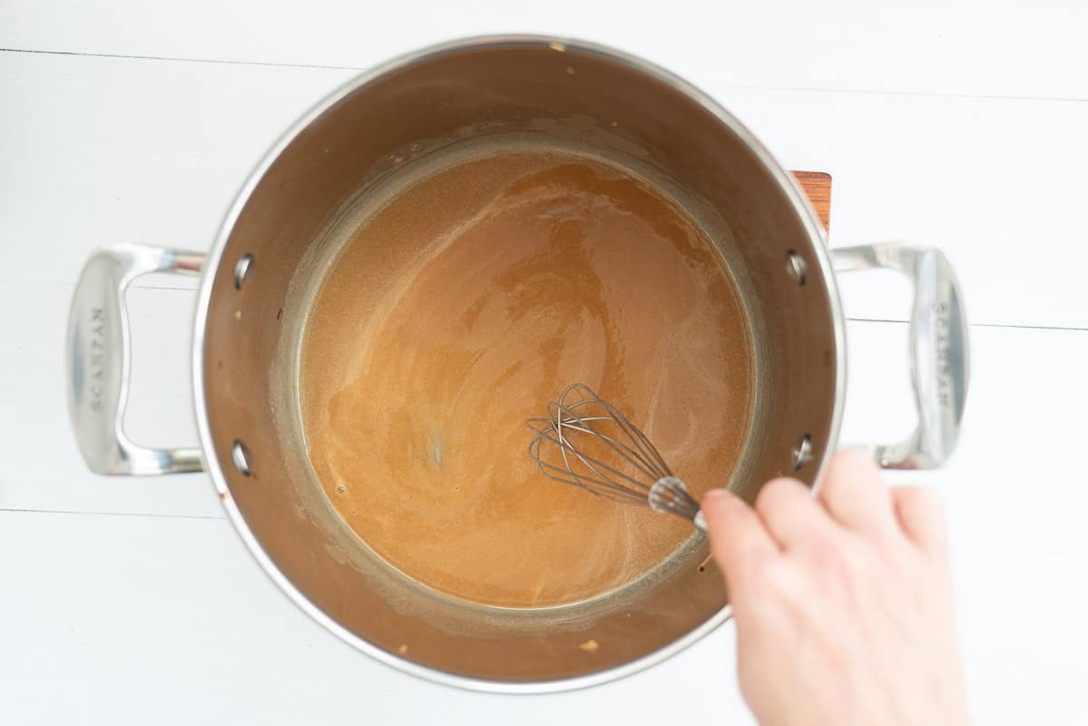 carmel sauce being whisked in a sauce pan