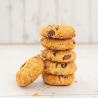 stack of 5 cornflake cookies on a white background, raisins visible