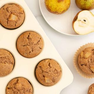 top down view of pear muffins in a cream muffin tin