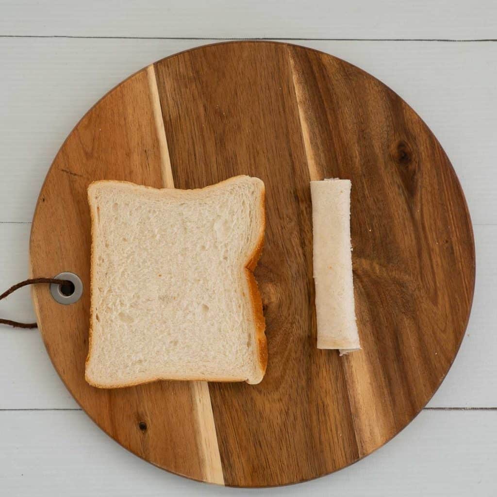 Slice of bread rolled into a sausage, like a pinwheel scroll