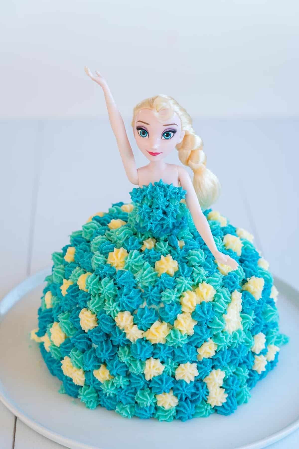 Birthday cake topped with an Elsa Doll, decorated with butter cream to look like a dress