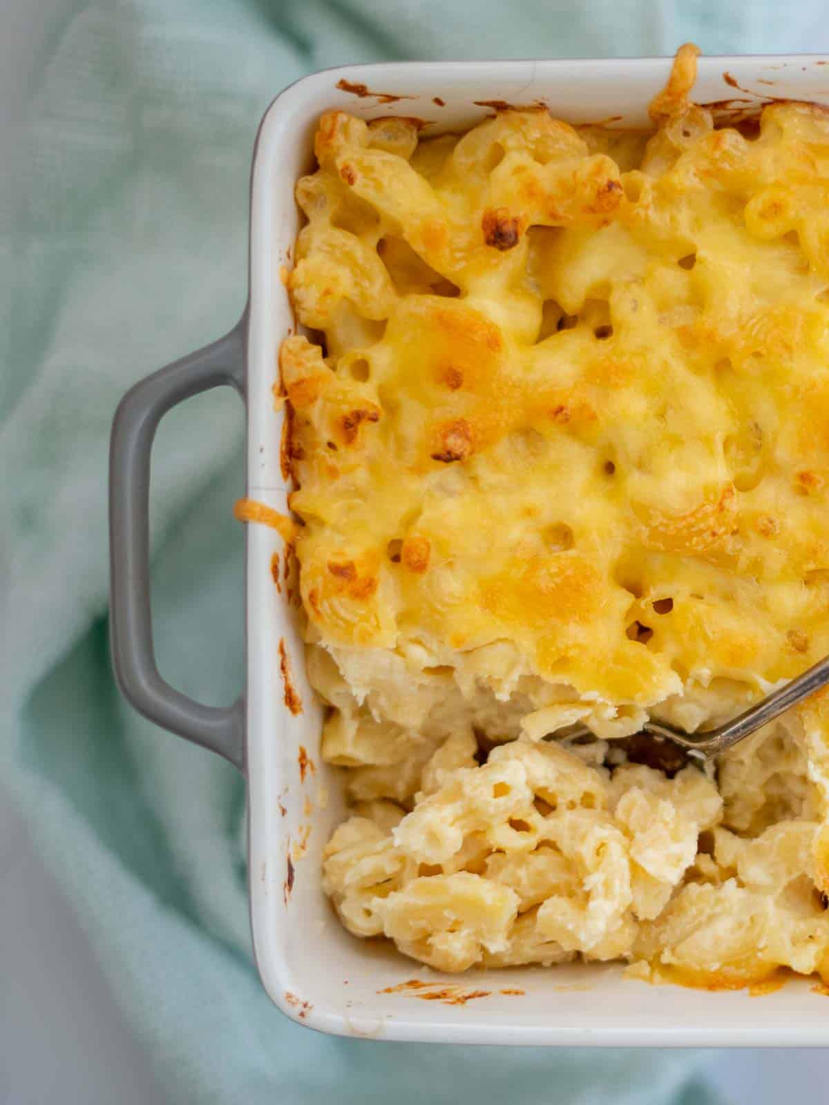 Baked mac and cheese ready to serve with melted golden cheese on top