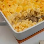 Spoon scooping out a serve of mac and cheese.