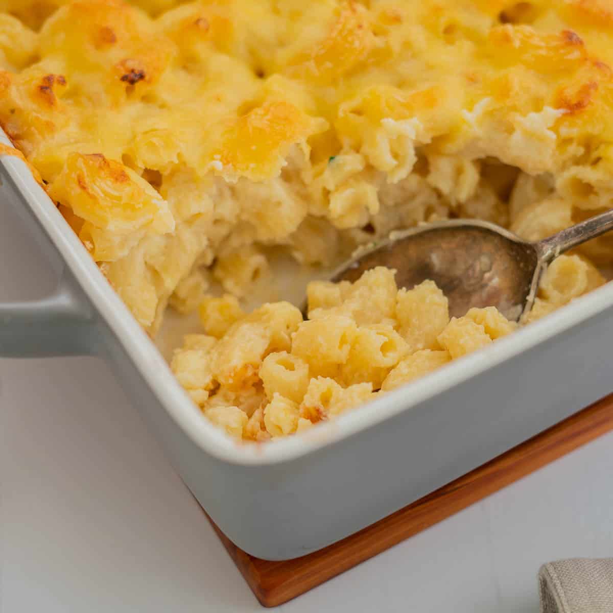 Baked mac and cheese being served with a large serving spoon