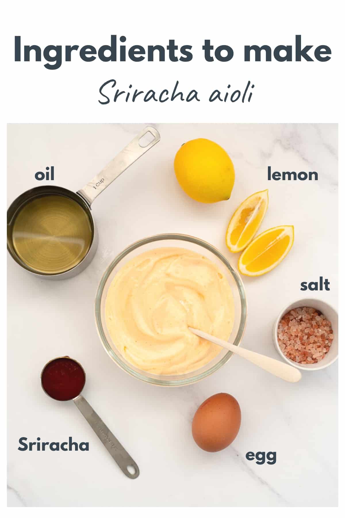 a bowl of sriracha aioli surrunded by lemons, oil. salt, sriracha and eggs