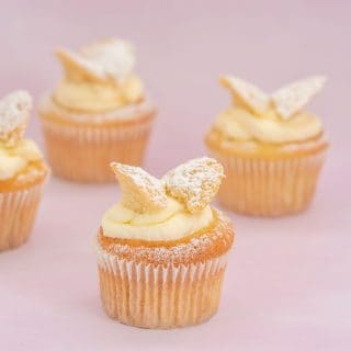 4 butterfly cupcakes on a pink background