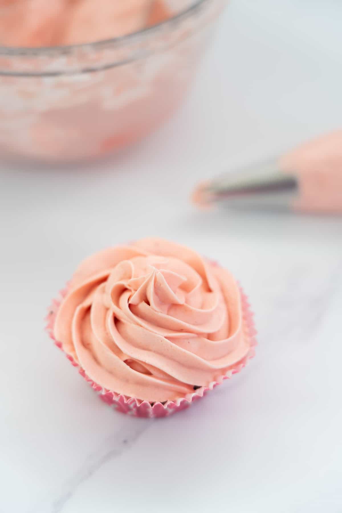 cupcake frosted with pink strawberry buttercream