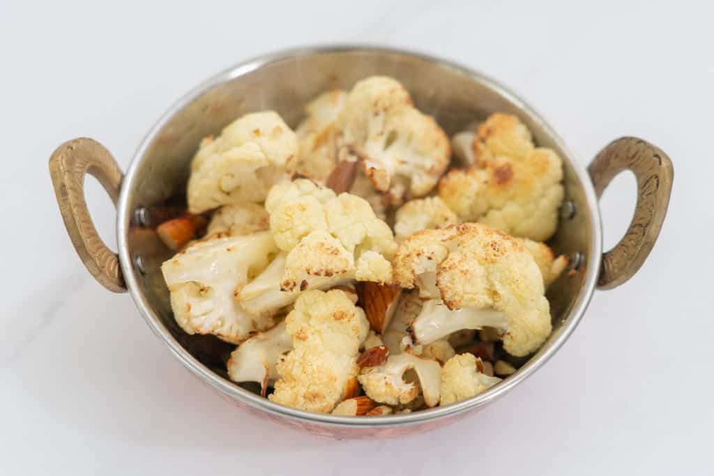 roasted cauliflower and almonds garnished with coriander leaves