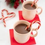 2 mugs of peppermint hot chocolate with candy canes