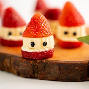 Strawberries, banana slices and cream cheese made to look like Santas.