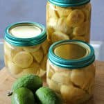 3 different sized preserving jars filled with feijoas.