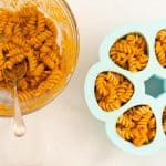 Baby pasta portioned into a blue silicone freezing container ready to freeze.
