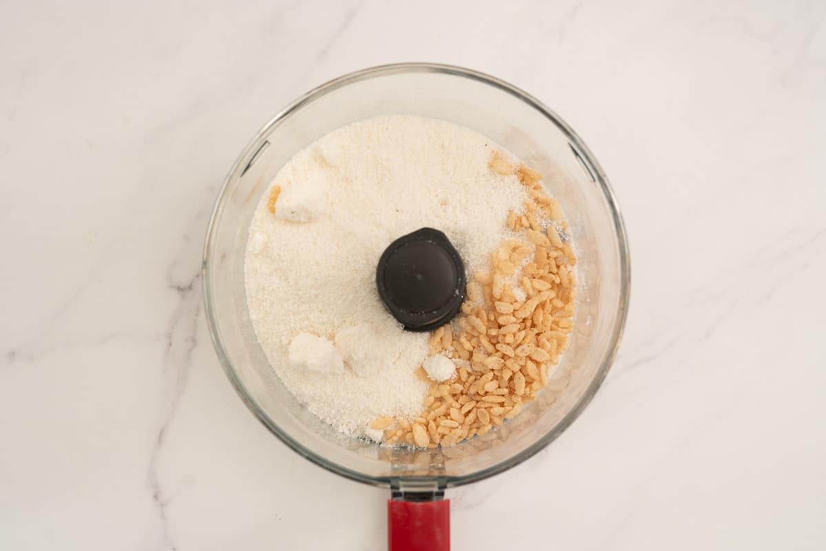 Desiccated coconut and rice bubbles in a food processor.