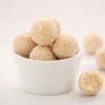 A small white bowl of coconut balls.