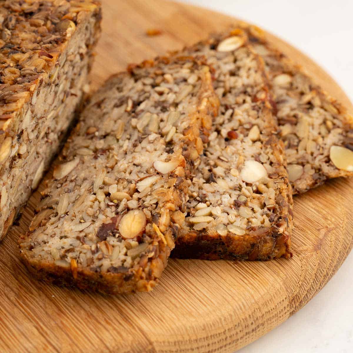 Close up of oat bread, nuts and seeds visible in the bread.