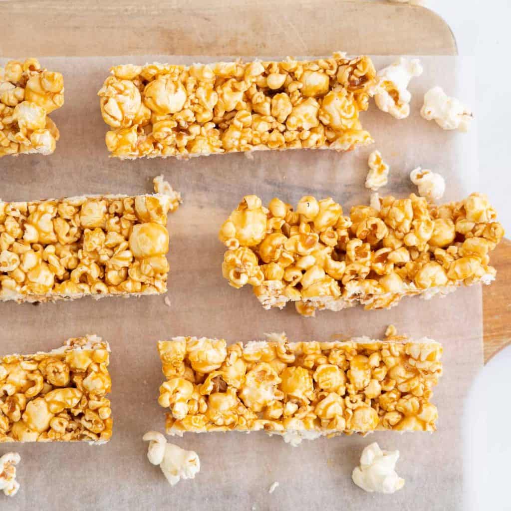 Popcorn bars on a wooden chopping board.