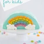 Rainbow Cake: Half round cake standing on a white serving platter decorated with a rainbow of jellybeans with text overlay.