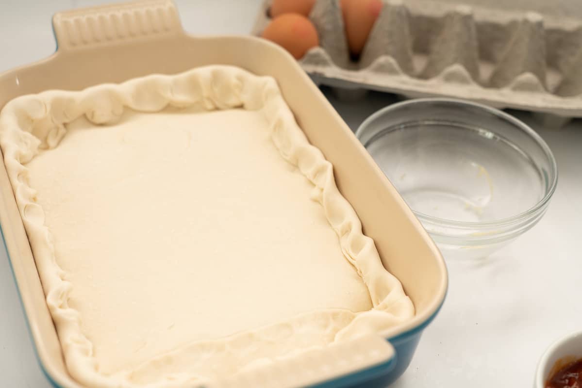 An uncooked pie, pastry folded and crimped around the edges.