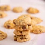 4 gluten free vegan chocolate chip cookies stacked in a tower.