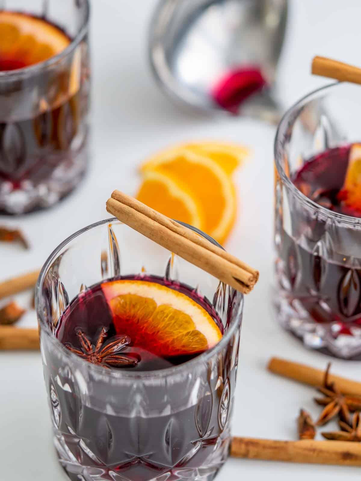 A cut glass tumbler filled with mulled wine.